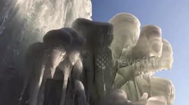 Leaking pipe creates 10m-high frozen waterfall at abandoned building