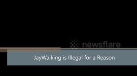 Man jaywalking across road near intersection nearly gets hit by car.