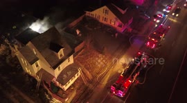 House fire with firefighters putting it out