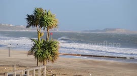 Stormy sea and surfers during high winds at Bournemouth 4 January 2018