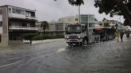 Bus being towed through flood waters on Auckland’s Tamaki Drive
