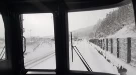 Train travelling on snow covered tracks
