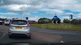 Car cuts off truck in roundabout