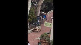 San Luis Obispo Homeless man eats fruit from a tree