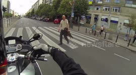 Drunk man crosses the road on the red light in front of a bus and a motorcycle