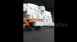 Overloaded tricycle drives backwards on road