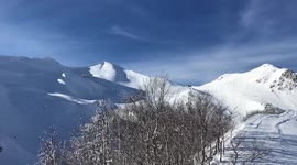 Beautiful winter panorama of a snowy mountains and ski tracks