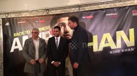 Amir Khan poses for photos with his new promoter Eddie Hearn
