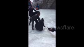 Tourists rescued from beneath river ice