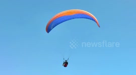 Paraglider crashes into electricity pole