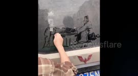 Former art teacher creates dust drawings on dirty cars