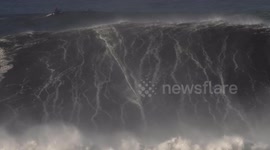 Big wave surfers ride monster swell off Nazaré