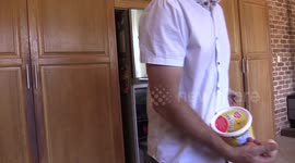 Man cooks egg on frypan heated by the Sun on hot day