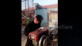 Man's bizarre technique cranking up tractor