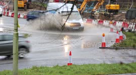 Cars drive through flooded Hampshire roundabout after heavy rain