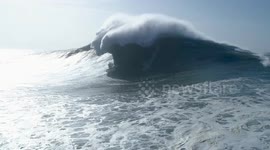 Professional surfer rides giant wave off Nazare