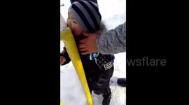 Boy gets his tongue stuck to icy metal fence