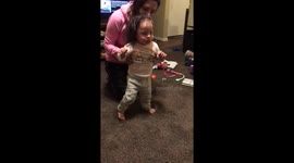 Toddler with Down Syndrome taking first steps unassisted.