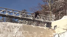 Skier front-flip out of dam wall