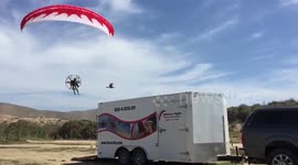 Paramotor Pilot flying over truck and trailer