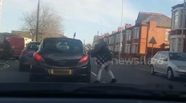 Thug pedestrian smashes fist through driver's window on Merseyside