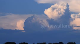 Birds Flying in Front of Developing Storm at Sunset