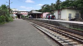 Old train arrives at railway station in Sri Lanka