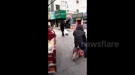 Woman crawling on street with fiancé aside