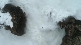 Amazing drone video shows daredevil slacklining above giant waves in Portugal