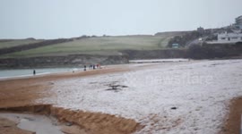 Snowstorm and snow settling on a beach in cornwalll