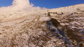 Drone Ascends Snow Mountain