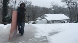 Hack for shoveling snow off driveway with sheet of plywood.
