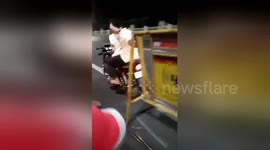 Chennai biker gang drag traffic barricade along road