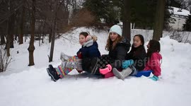 Girls sledding - all piled onto 1 sled