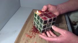 Man solves burning candle Rubik's Cube
