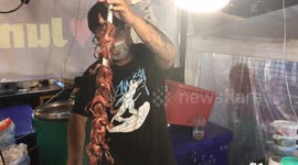 Spit-roast quail on sale at market stall