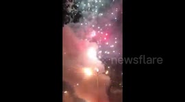 Thousands of fireworks go off when stall catches fire
