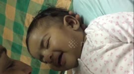 Sleeping baby smiles when mum says 'I love you' to her