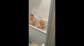Doggy makes baby laugh in the bath