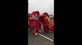 Dragons for Chinese New Year share an intimate moment with a little kiss during New Year parade in Cambodia, Phnom Penh