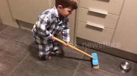 Toddler prepares for Winter Olympics curling in kitchen