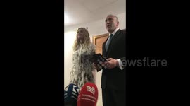 Rita Ora take a medal from the prime minister of Kosovo