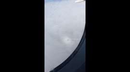 Airplane reflection surrounded by a rainbow