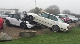 BMW leaves road and crashes into Mini on garage forecourt