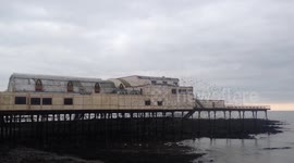 Thousands of little starlings burst out from under The Royal Pier, Aberystwyth, West Wales, UK