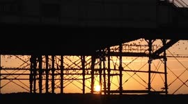 Thousands of starlings roosting under The Royal Pier at sunset