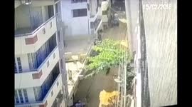 Biker dodges death after building crashes on him