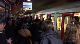 Tube train on crowded platform