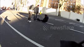woman sits in road to be run over