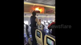 Passenger's carry-on catches fire in plane's overhead bin
